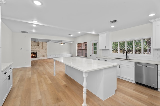 3 Briarwood Dr, Conroe, TX 77301 - kitchen with stainless steel dishwasher, open floor plan, a fireplace, decorative backsplash, and recessed lighting