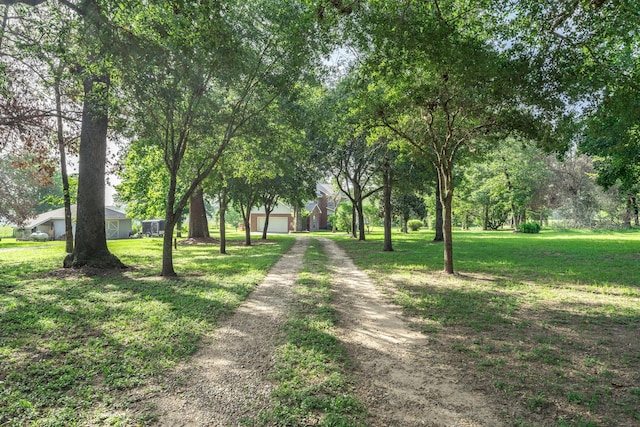 13141 Nicholson Rd, Conroe, TX 77303 - surrounding community featuring driveway, a yard, and a garage