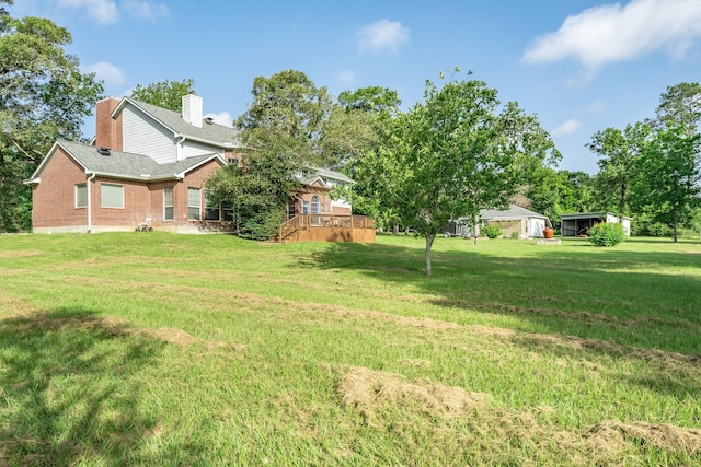 13141 Nicholson Rd, Conroe, TX 77303 - view of green lawn featuring a deck