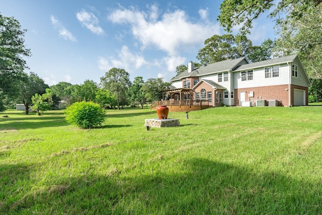13141 Nicholson Rd, Conroe, TX 77303 - view of grassy yard with a garage and a deck