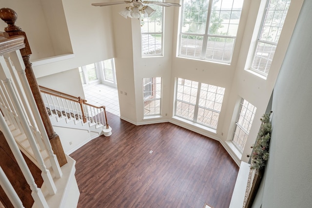 13141 Nicholson Rd, Conroe, TX 77303 - entrance foyer with dark wood-style flooring, stairway, a high ceiling, and ceiling fan