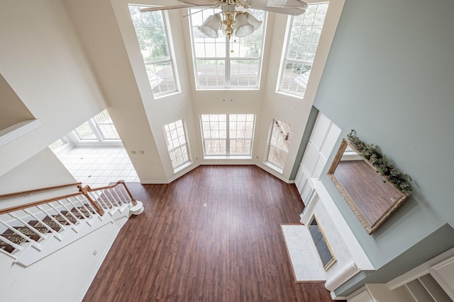 13141 Nicholson Rd, Conroe, TX 77303 - unfurnished living room with a ceiling fan, wood finished floors, and a towering ceiling