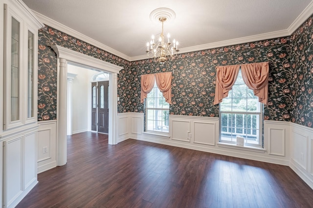 13141 Nicholson Rd, Conroe, TX 77303 - unfurnished dining area featuring a chandelier, dark wood-style floors, a wainscoted wall, wallpapered walls, and a decorative wall
