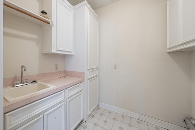 13141 Nicholson Rd, Conroe, TX 77303 - kitchen featuring light floors, white cabinetry, and light countertops