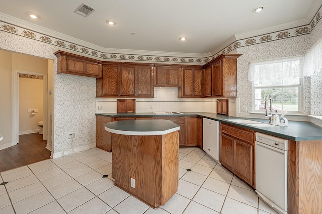 13141 Nicholson Rd, Conroe, TX 77303 - kitchen featuring white dishwasher, a kitchen island, crown molding, dark countertops, and light tile patterned floors