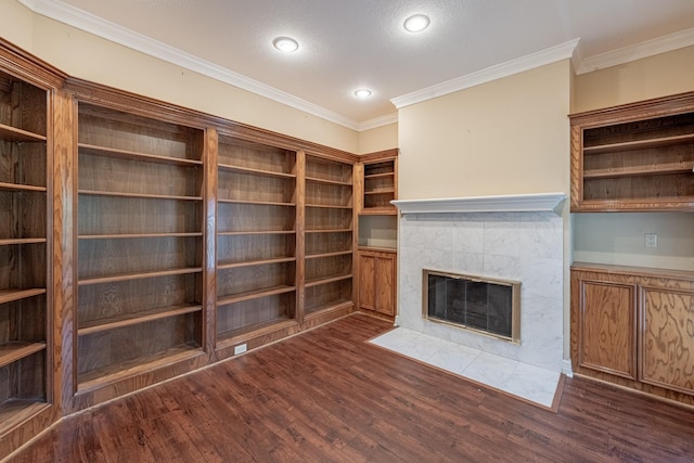 13141 Nicholson Rd, Conroe, TX 77303 - unfurnished living room with a tiled fireplace, dark wood finished floors, crown molding, and recessed lighting