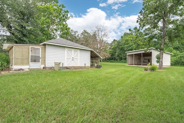 13141 Nicholson Rd, Conroe, TX 77303 - view of grassy yard with an outbuilding and view of wooded area
