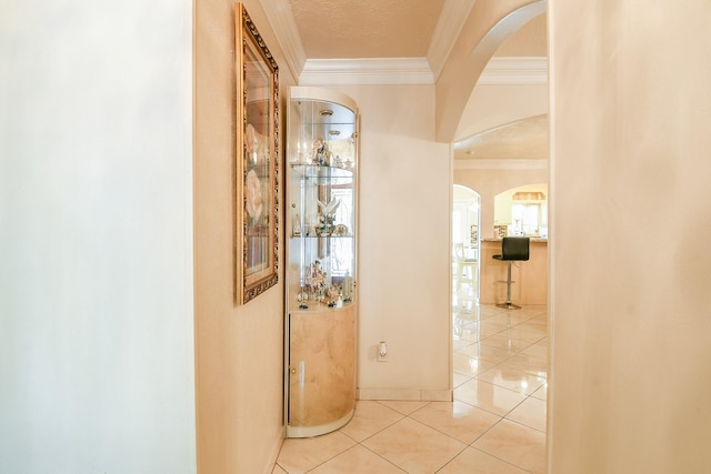 9411 Kingsvalley St, Houston, TX 77075 - hall with ornamental molding, arched walkways, and tile patterned floors