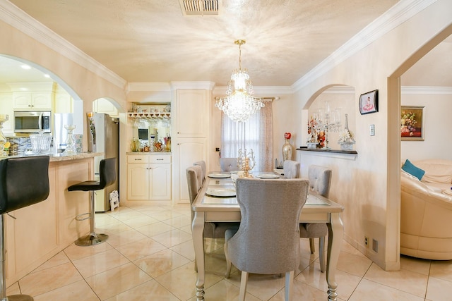 9411 Kingsvalley St, Houston, TX 77075 - dining room featuring a chandelier, crown molding, arched walkways, and light tile patterned floors