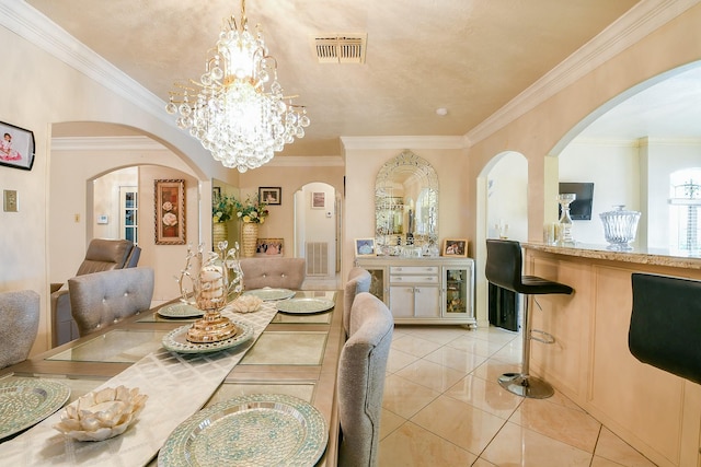 9411 Kingsvalley St, Houston, TX 77075 - dining area featuring light tile patterned floors, ornamental molding, a chandelier, arched walkways, and bar area