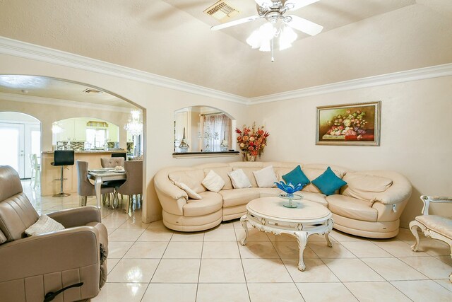 9411 Kingsvalley St, Houston, TX 77075 - living area with arched walkways, light tile patterned floors, a ceiling fan, and ornamental molding