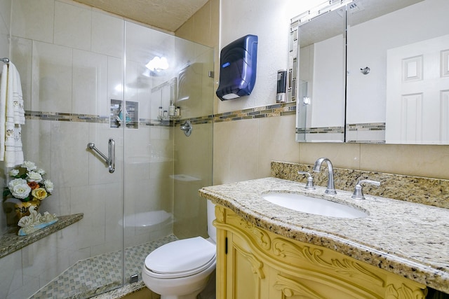 9411 Kingsvalley St, Houston, TX 77075 - full bathroom featuring vanity, a shower stall, and tile walls