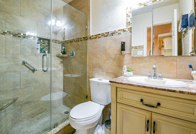 9411 Kingsvalley St, Houston, TX 77075 - bathroom with vanity, a stall shower, decorative backsplash, and tile walls