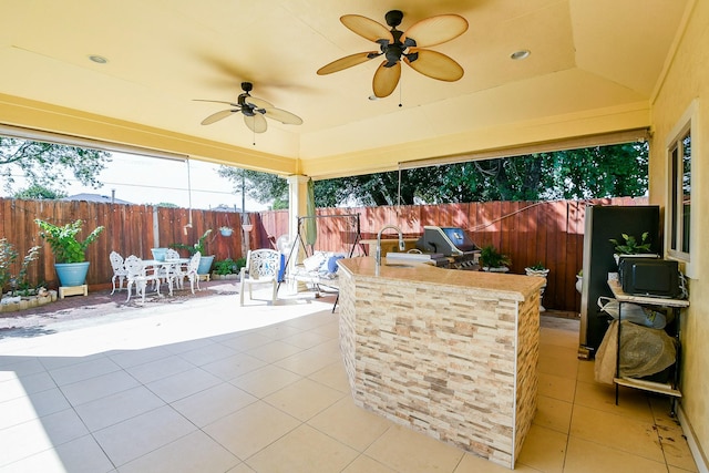 9411 Kingsvalley St, Houston, TX 77075 - fenced backyard with a patio, outdoor dining area, ceiling fan, and an outdoor kitchen