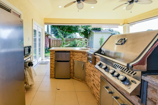 9411 Kingsvalley St, Houston, TX 77075 - view of patio / terrace with exterior kitchen, french doors, and ceiling fan