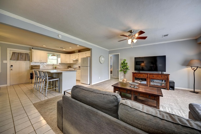 204 Meadow Ln, Brenham, TX 77833 - living room with ornamental molding, a ceiling fan, and light tile patterned floors