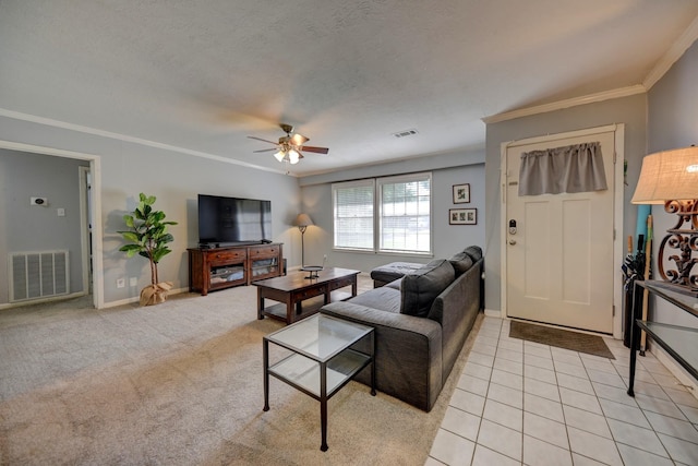 204 Meadow Ln, Brenham, TX 77833 - living area with crown molding, a ceiling fan, a textured ceiling, and light tile patterned floors