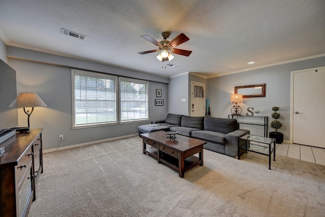 204 Meadow Ln, Brenham, TX 77833 - carpeted living room featuring a ceiling fan, ornamental molding, and a textured ceiling