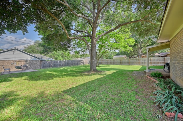 204 Meadow Ln, Brenham, TX 77833 - fenced backyard with a patio area