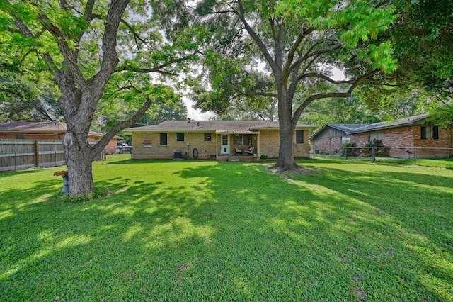 204 Meadow Ln, Brenham, TX 77833 - back of house featuring brick siding and a patio area