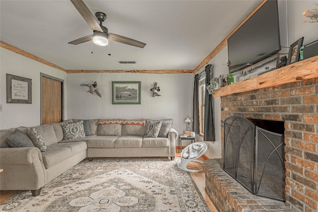 1205 W Houston Ave W, Crockett, TX 75835 - living area featuring ceiling fan, a fireplace, and wood finished floors