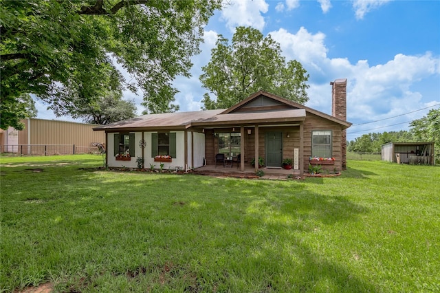 1205 W Houston Ave W, Crockett, TX 75835 - rear view of property with a chimney and covered porch