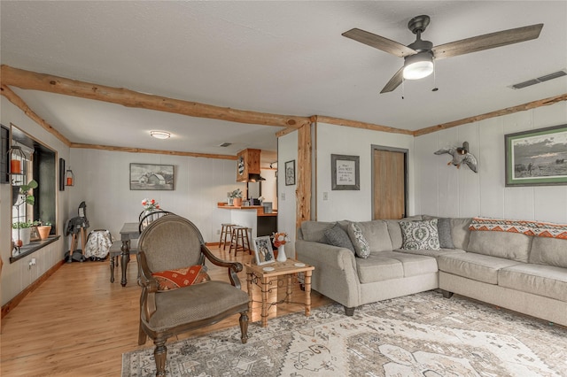 1205 W Houston Ave W, Crockett, TX 75835 - living area featuring light wood-style flooring, ceiling fan, wooden walls, and beamed ceiling