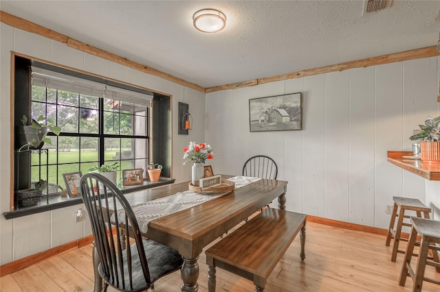 1205 W Houston Ave W, Crockett, TX 75835 - dining room with light wood finished floors and a textured ceiling