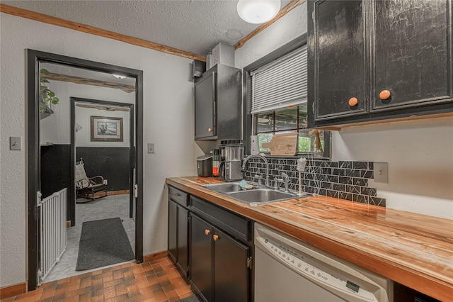 1205 W Houston Ave W, Crockett, TX 75835 - kitchen featuring white dishwasher, brick patterned flooring, decorative backsplash, wood counters, and a textured ceiling