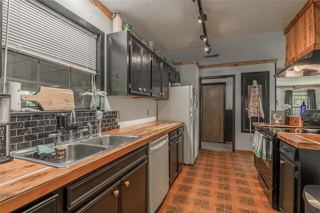 1205 W Houston Ave W, Crockett, TX 75835 - kitchen with butcher block counters, white appliances, under cabinet range hood, tasteful backsplash, and a textured ceiling