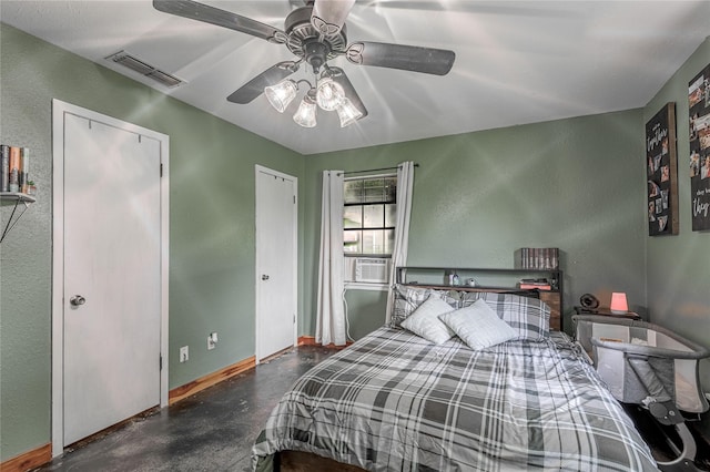 1205 W Houston Ave W, Crockett, TX 75835 - bedroom with finished concrete flooring, cooling unit, a textured wall, and a ceiling fan