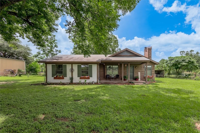 1205 W Houston Ave W, Crockett, TX 75835 - rear view of property featuring a chimney and a lawn