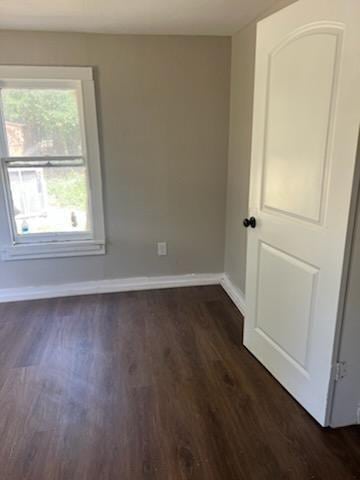 3109 Anita St, Houston, TX 77004 - empty room with dark wood finished floors and healthy amount of natural light