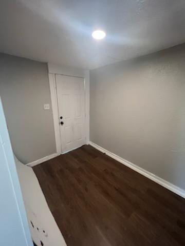 3109 Anita St, Houston, TX 77004 - spare room featuring baseboards and dark wood-style floors
