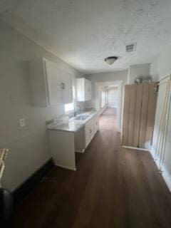 3109 Anita St, Houston, TX 77004 - kitchen with white cabinetry, dark wood-style floors, and light countertops