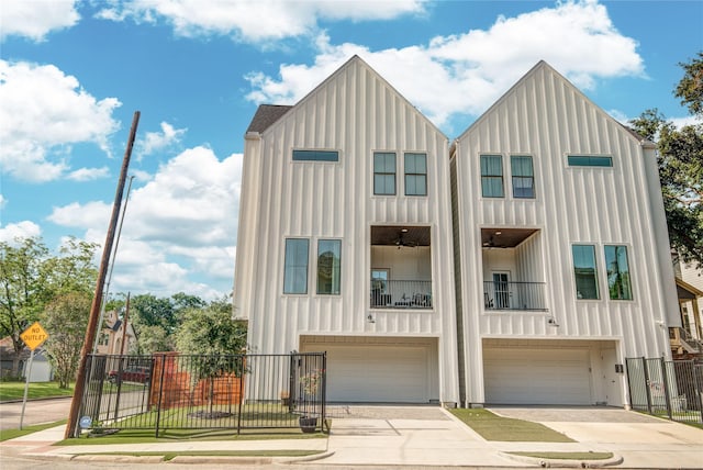 818 Fisher St, Houston, TX 77018 - view of front of property with board and batten siding, an attached garage, driveway, and a balcony
