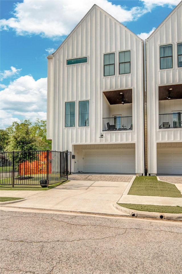 818 Fisher St, Houston, TX 77018 - view of front of house featuring board and batten siding, driveway, and a garage