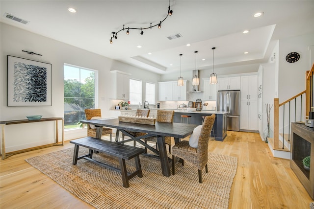 818 Fisher St, Houston, TX 77018 - dining room featuring a tray ceiling, stairway, light wood-style flooring, and recessed lighting