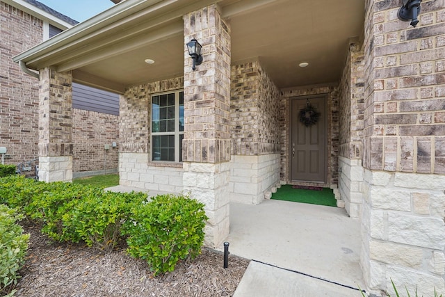10126 Bayou Oaks Dr, Conroe, TX 77385 - view of exterior entry featuring brick siding and a porch