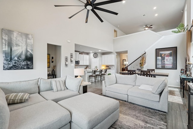 10126 Bayou Oaks Dr, Conroe, TX 77385 - living area with ceiling fan, wood finished floors, stairs, and high vaulted ceiling