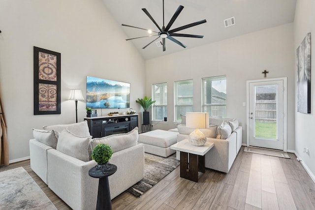 10126 Bayou Oaks Dr, Conroe, TX 77385 - living room featuring high vaulted ceiling, a ceiling fan, and wood finished floors