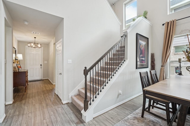 10126 Bayou Oaks Dr, Conroe, TX 77385 - foyer featuring a chandelier, light wood-style flooring, and stairs