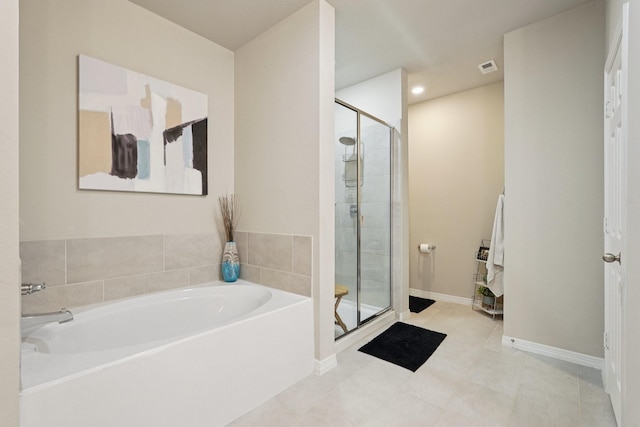 10126 Bayou Oaks Dr, Conroe, TX 77385 - full bathroom with a stall shower, a garden tub, and tile patterned floors