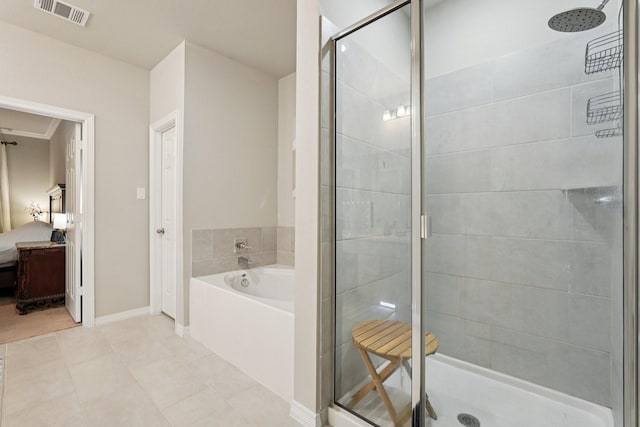 10126 Bayou Oaks Dr, Conroe, TX 77385 - bathroom with a shower stall, a garden tub, and tile patterned floors