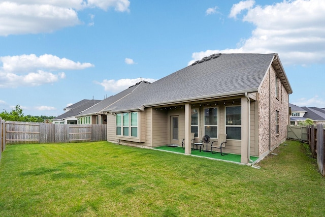 10126 Bayou Oaks Dr, Conroe, TX 77385 - rear view of house with a fenced backyard, a patio area, and a shingled roof