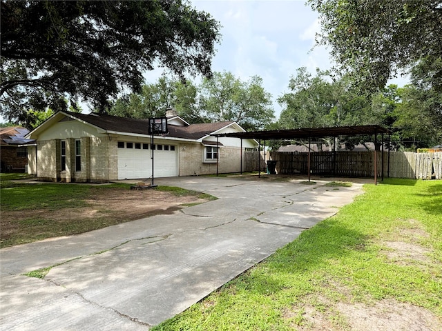 1006 Fairlane Dr, Ganado, TX 77962 - view of front of house featuring concrete driveway, an attached garage, brick siding, and a carport
