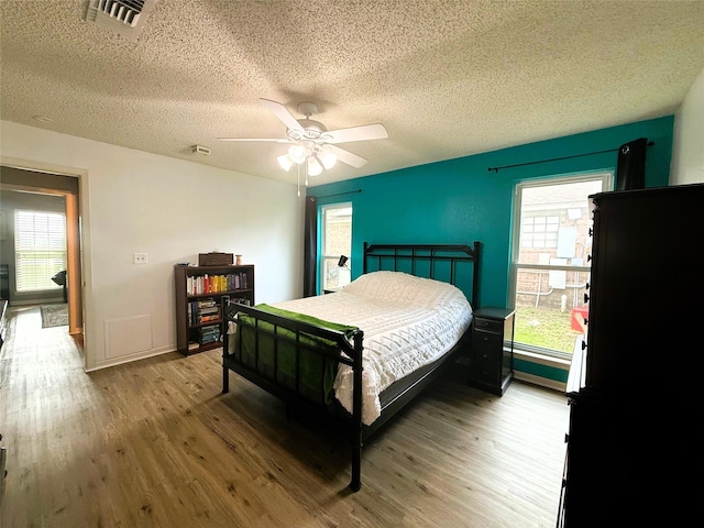 1006 Fairlane Dr, Ganado, TX 77962 - bedroom with a textured ceiling, wood finished floors, and a ceiling fan