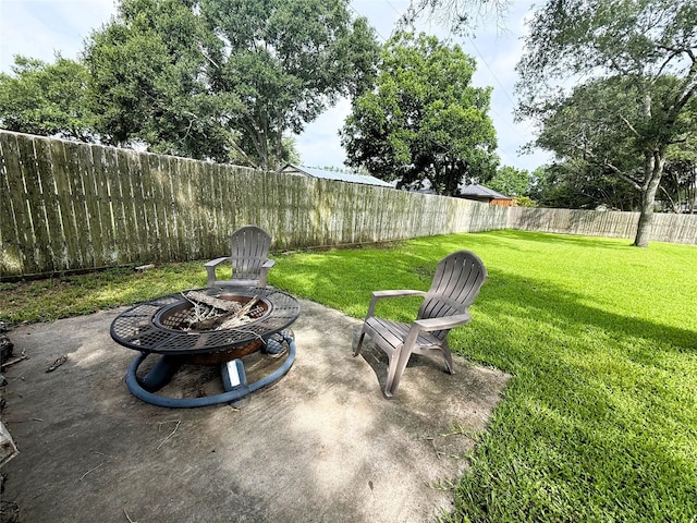 1006 Fairlane Dr, Ganado, TX 77962 - fenced backyard with an outdoor fire pit and a patio area
