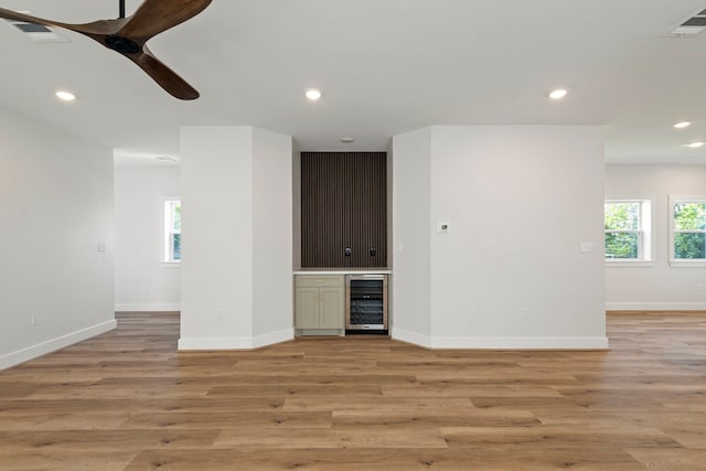 3224 Omega St, Houston, TX 77022 - unfurnished living room with beverage cooler, a ceiling fan, light wood-type flooring, and recessed lighting