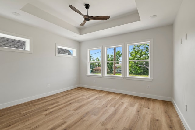 3224 Omega St, Houston, TX 77022 - spare room featuring a raised ceiling, a ceiling fan, and light wood finished floors